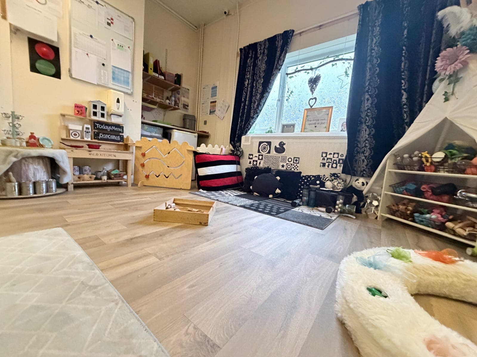 Staff playing with babies in the baby room